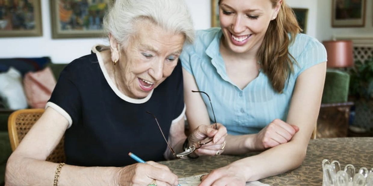 Elderly woman and younger woman smiling together – Elder Care & Care Management